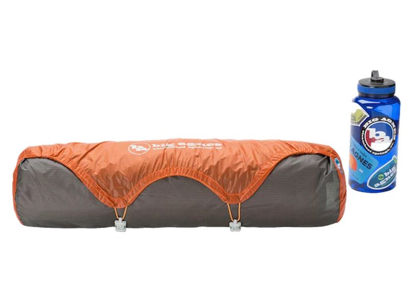 Big Agnes Copper Spur UL3 packed size shown next to a water bottle